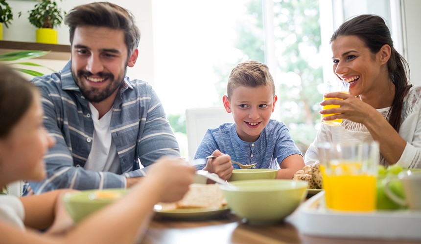 Savings account - Family of four eating breakfast at home